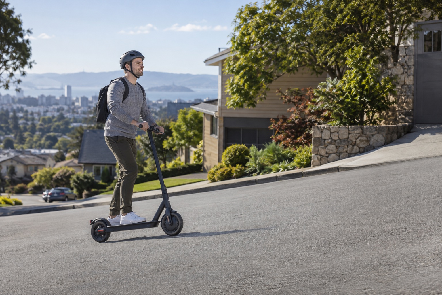 Adult commuter riding a scooter on a gentle urban incline