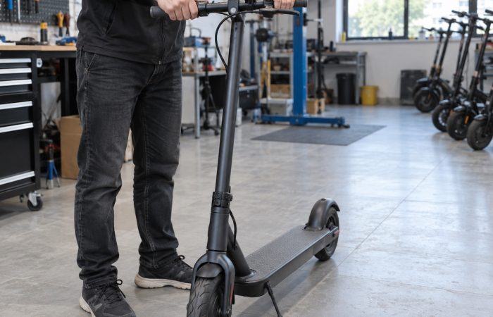 A parked scooter being checked for handlebar movement
